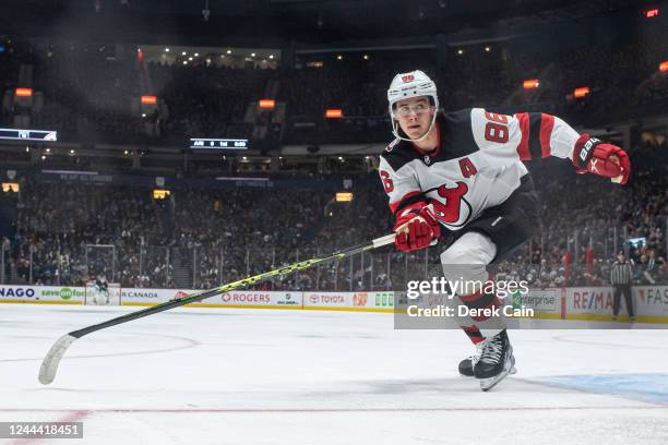 Jack Hughes of the New Jersey Devils tracks the play during the second period of their NHL game against the Vancouver Canucks at Rogers Arena on...