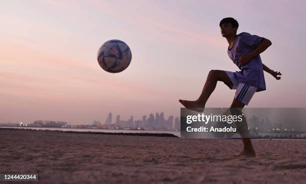 Child plays ball on the beach ahead of the 2022 FIFA World Cup in Doha, Qatar on November 01, 2022.