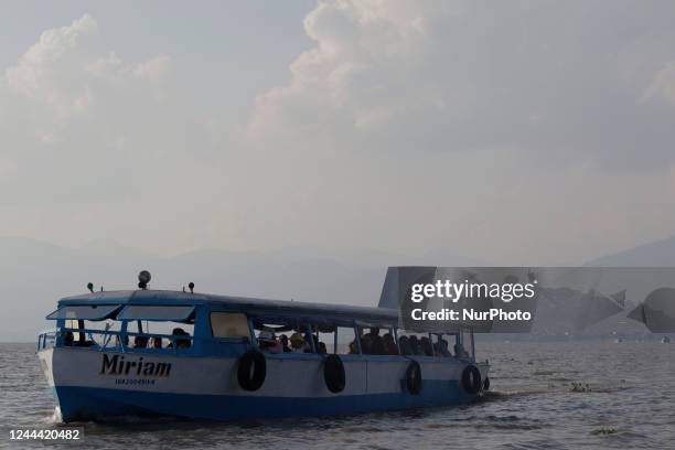 View of a boat near Janitzio Island located in the state of Michoacán, Mexico, where several people attend the community pantheon to clean the tombs...