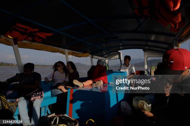 Crew members of a boat heading to Isla de Janitzio located in the state of Michoacán, Mexico, where several people attend the community pantheon to...