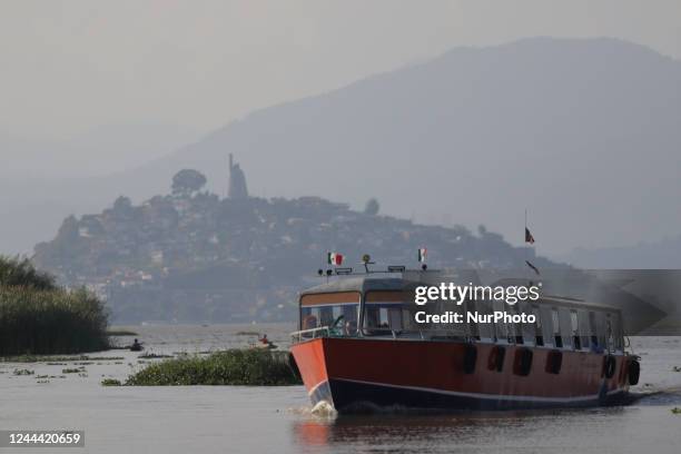 View of a boat near Janitzio Island located in the state of Michoacán, Mexico, where several people attend the community pantheon to clean the tombs...