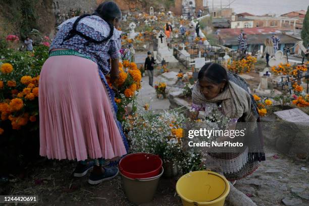 Inhabitants of the Island of Janitzio located in the state of Michoacán, Mexico, attend the community pantheon to clean the graves of their deceased...