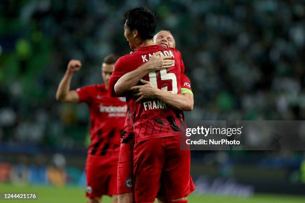 Sebastian Rode of Frankfurt celebrates the victory with Daichi Kamada at the end of the UEFA Champions League Group D football match between Sporting...