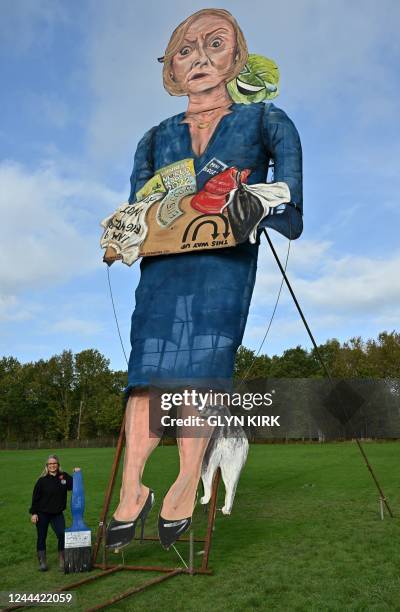 Artist Andrea Deans poses with the Edenbridge Bonfire Society's 2022 'Celebrity Guy', former British prime minister Liz Truss, during the unveiling...