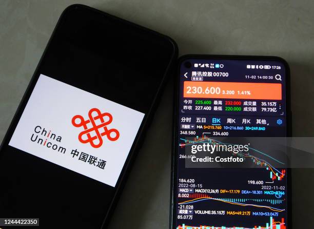 Mobile phone displays the share prices of China Unicom and Tencent Holdings in Yichang, Hubei province, China, Nov 2, 2022. According to the State...