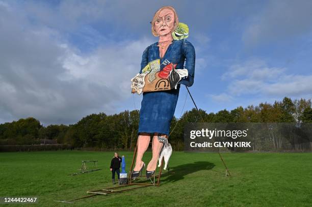 Artist Andrea Deans poses with the Edenbridge Bonfire Society's 2022 'Celebrity Guy', former British prime minister Liz Truss, during the unveiling...