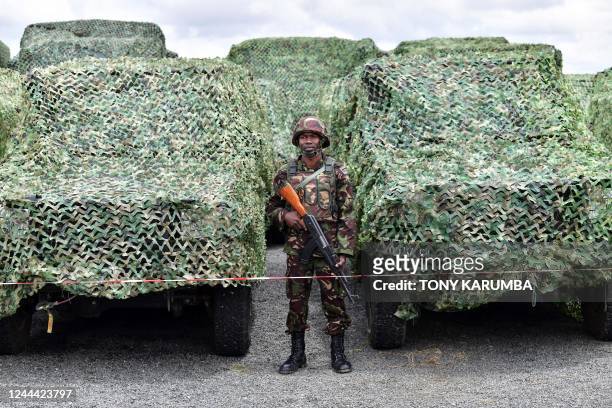 Kenya Defence Forces soldier stands next to military vehicles while attending a flag presentation ceremony by Kenya's President William Ruto before...