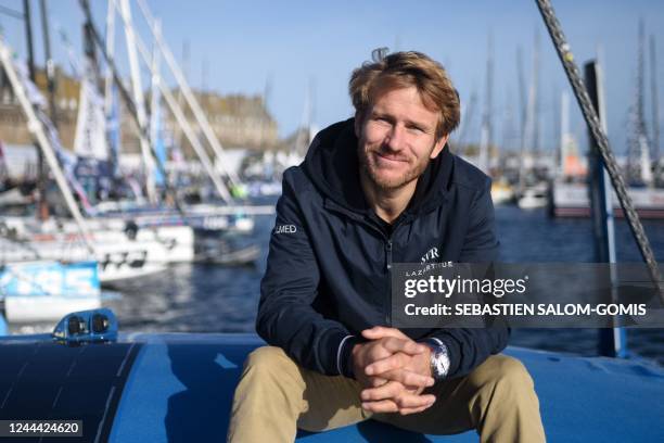 French skipper Francois Gabart poses for a picture aboard his Ultimate multihull SVR-Lazartigue, at the 'Village de Saint-Malo', the starting point...