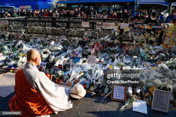 Buddhist monk pays tribute to the victims of the Halloween celebration stampede, on Itaewon street near to the scene on November 02, 2022 in Seoul,...