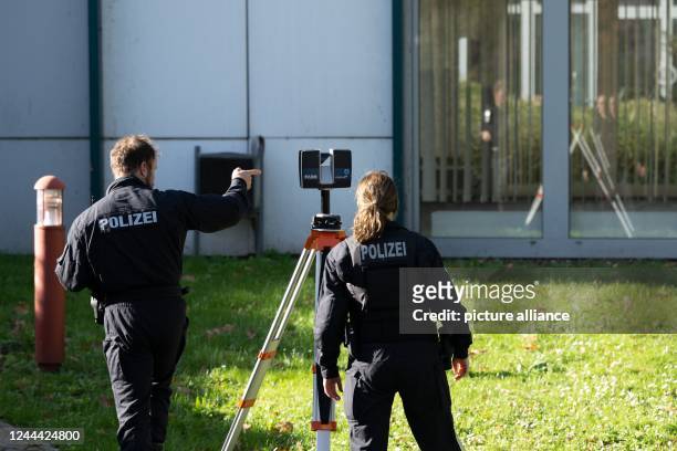 November 2022, Saxony, Bautzen: Police fire investigators install a laser scanner on a tripod in front of the planned refugee accommodation....