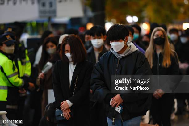 People pay tribute to the victims of the Halloween celebration stampede, on Itaewon street near to the scene on November 02, 2022 in Seoul, South...