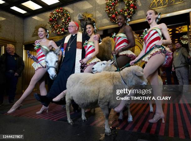 The Archbishop of New York, Cardinal Timothy Dolan , joins Radio City Rockettes Christine Sienicki, Jaclyn de Nicola, Jojo Carmichael and Karen...