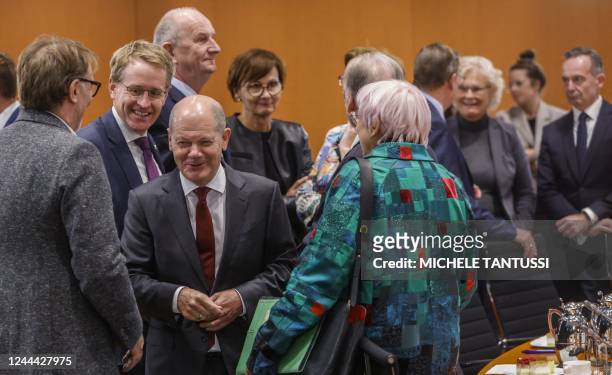 German Chancellor Olaf Scholz walks Schleswig-Holstein's State Premier Daniel Guenther , Brandenburg's State Premier Dietmar Woidke , the Federal...
