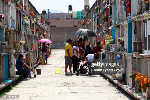 Relatives and friends visit their loved ones to celebrate the Day of the Dead holiday at the Municipal Cemetery of Nezahualcoyotl. On November 1,...