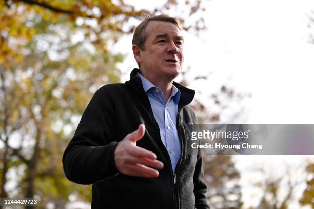 Sen. Michael Bennet answers questions from reporters after drop off his ballot at Washington Park in Denver, Colorado on Wednesday, November 2, 2022.
