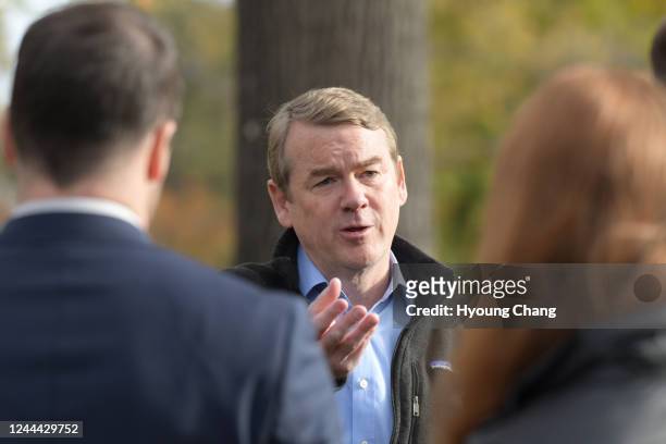 Sen. Michael Bennet answers questions from reporters after drop off his ballot at Washington Park in Denver, Colorado on Wednesday, November 2, 2022.