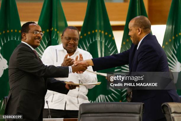 Redwan Hussein , Representative of the Ethiopian government, and Getachew Reda , Representative of the Tigray People's Liberation Front , shake hands...