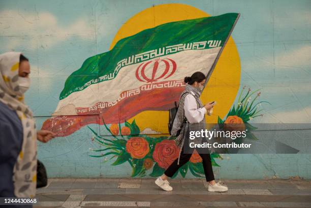 An Iranian woman walks on the streets of Tehran without a mandatory headscarf on November 1, 2022 in Tehran, Iran. Nationwide protests began in Iran...