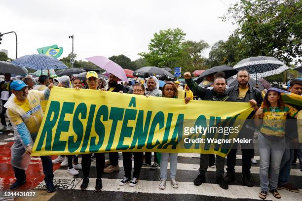Supporters of Jair Bolsonaro hold a banner that reads in Portuguese 'Civil Resistance' during a demostration in front of the Eastern Military Command...
