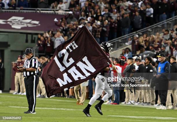 Texas A&M Aggies player Connor Choate carries the 12th man flag prior to start of the college football game featuring the Ole Miss Rebels and the...