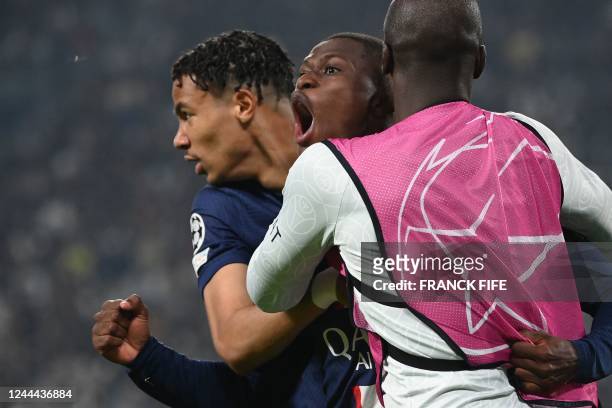 Paris Saint-Germain's Portuguese defender Nuno Mendes celebrates with teammates after scoring a goal during the UEFA Champions League 1st round day 6...