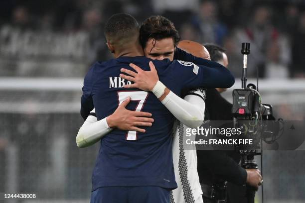 Juventus' Italian forward Federico Chiesa hugs Paris Saint-Germain's French forward Kylian Mbappe after the UEFA Champions League 1st round day 6...