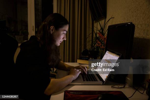 Woman checks the schedule for planned power cuts in her area on energy company DTEKs website November 02, 2022 in Kyiv, Ukraine. Electricity and...