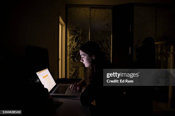 Woman checks the schedule for planned power cuts in her area on energy company DTEKs website November 02, 2022 in Kyiv, Ukraine. Electricity and...