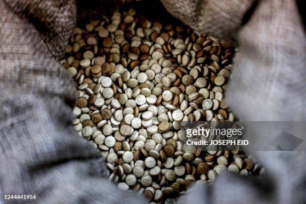 This picture taken on July 27, 2022 shows a view of sacks of confiscated captagon pills at the judicial police headquaters in the town of Kafarshima...