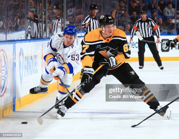 Rickard Rakell of the Pittsburgh Penguins controls the puck against Jeff Skinner of the Buffalo Sabres during an NHL game on November 2, 2022 at...