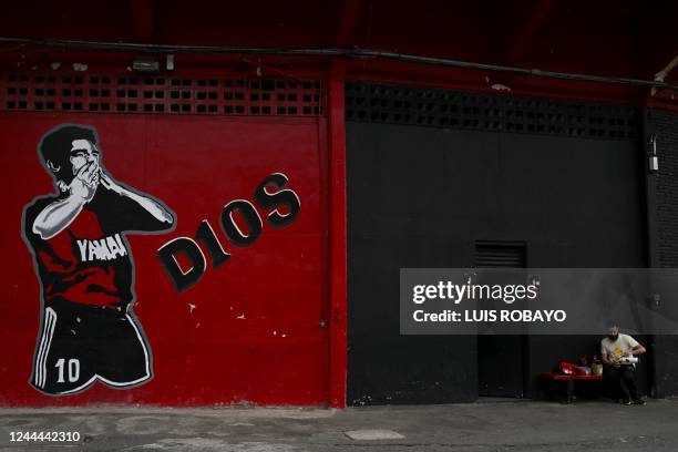 Man drinks mate next to a mural of the late Argentine football star Diego Maradona at Coloso Del Parque Marcelo Bielsa stadium, home of Newell's Old...