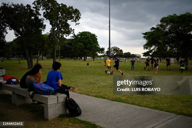 Youngsters play football on the banks of the Parana river in Rosario, Argentina, on October 20, 2022. - Local passion, makeshift pitches, good...