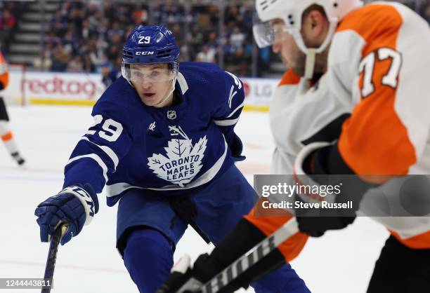 Toronto Maple Leafs right wing Pontus Holmberg tries to poke the puck away from Philadelphia Flyers defenseman Tony DeAngelo as the Toronto Maple...