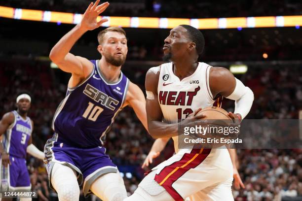 Bam Adebayo of the Miami Heat drives against Domantas Sabonis of the Sacramento Kings during the second half at FTX Arena on November 2, 2022 in...