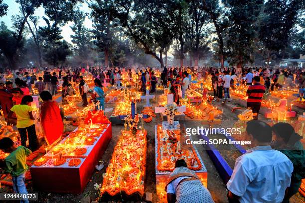 Christian family members pay respect and offer prayers beside the graves of their relatives during All Souls' Day. Christian devotees gather at the...