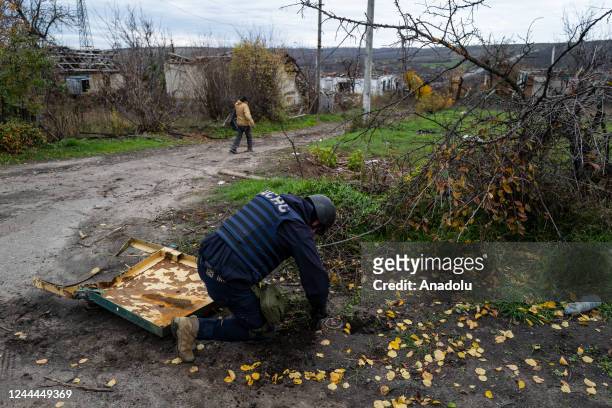 Member of mine clearance team from Kharkiv examines a mine during the mine search operation in Izyum, Ukraine on November 02, 2022.