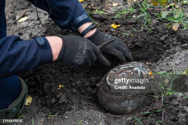 Member of mine clearance teams from Kharkiv examines a mine during the mine search operation in Izyum, Ukraine on November 02, 2022.