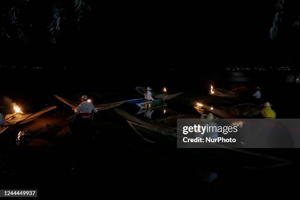 Fishermen from Isla de Janitzio located in the State of Michoacán, Mexico, aboard a canoe with a gasoline-powered sail during a trip to mark the Day...