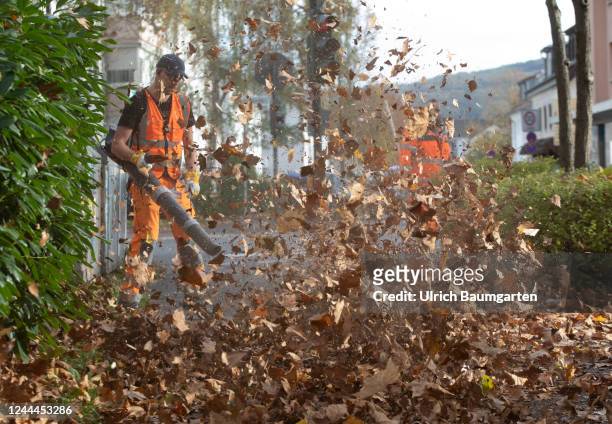 Removal of autumn leaves with leaf blowers and brooms by municipal employees on November 03, 2022 in Bonn, Germany.