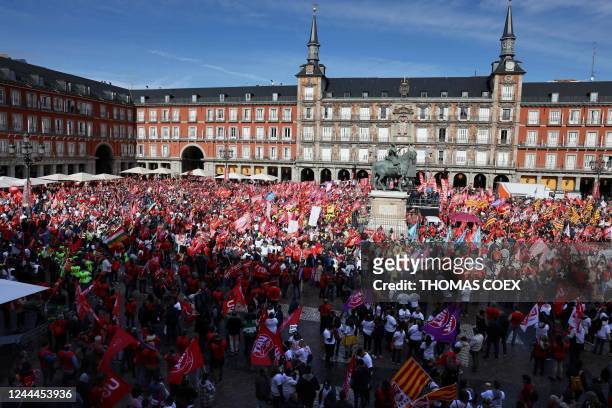 Protestors wave trade union flags during a demonstration called by the CCOO and UGT trade unions, demanding decent wage increases to maintain...