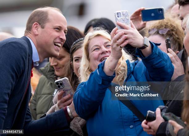 Prince William, Prince of Wales meets members of the public and takes selfies after a visit to The Street - a community hub that helps local...