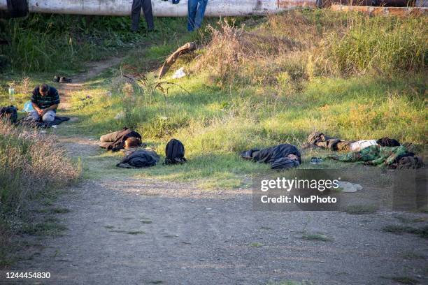 Refugees and migrants resting, sleeping and praying near, next to river as they are hiding from the authorities. Asylum seekers as seen near Idomeni...