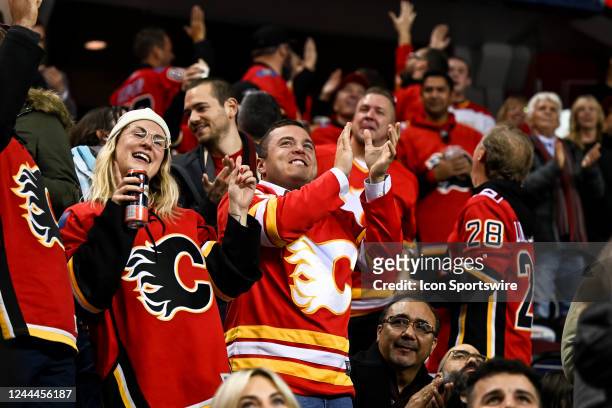 Calgary Flames fans cheer a goal by their team during the third period of an NHL game between the Calgary Flames and the Seattle Kraken on November 1...
