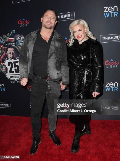 John Hennigan and Taya Valkyrie attend The Asylum's 25th Anniversary Party held at Pacific Park on The Santa Monica Pier on November 2, 2022 in Santa...