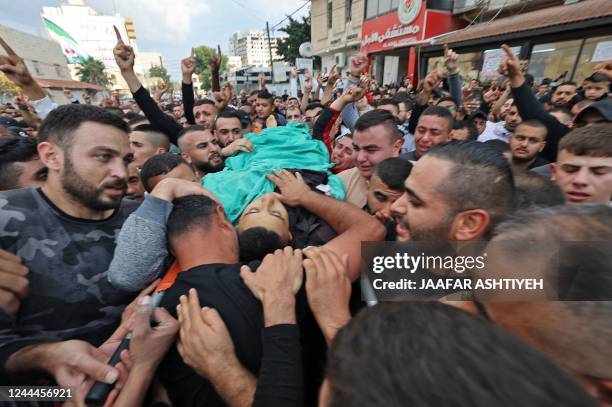 Graphic content / Mourners carry the body of Mohamed Khalaf, a Palestinian who was killed by Israeli forces during a raid to find him and others, on...