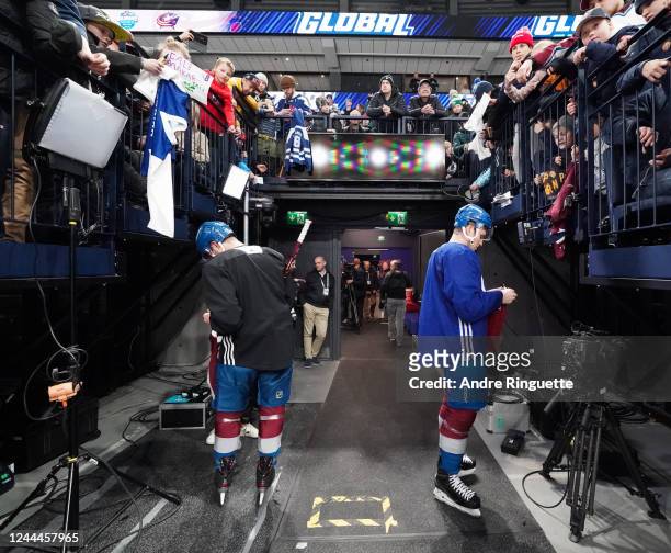 Devon Toews and Nathan MacKinnon of the Colorado Avalanche sign autographs after a practice session at the 2022 NHL Global Series Finland at Nokia...