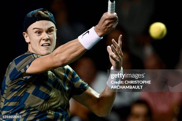 Denmark's Holger Rune returns the ball during the men's singles round of 8 tennis match between Denmark's Holger Rune and Russia's Andrey Rublev on...