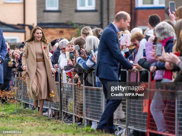 Catherine, Princess of Wales and Prince William, Prince of Wales greet the public as they arrive to visit "The Street" with Catherine, Princess of...
