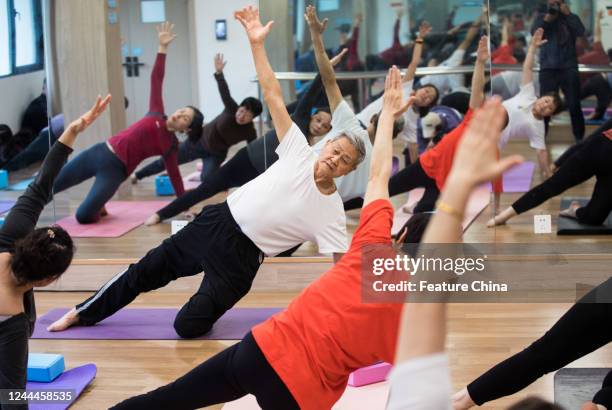 Yue Mingchao, 78-year-old, instructs his students in his free yoga class in Hangzhou in east China's Zhejiang province Monday, Oct. 31, 2022. Yue, a...