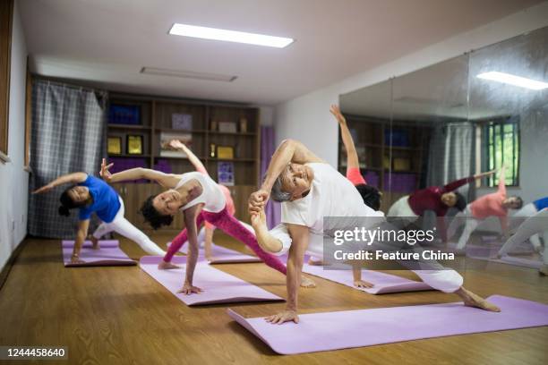 Yue Mingchao, 78-year-old, instructs his students in his free yoga class in Hangzhou in east China's Zhejiang province Monday, Oct. 31, 2022. Yue, a...
